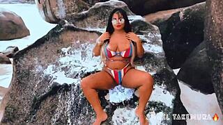 Angel Takemura goes topless for surfers on Grumari beach.