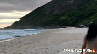 Angel Takemura goes topless for surfers on Grumari beach.