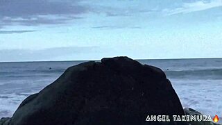 Angel Takemura goes topless for surfers on Grumari beach.