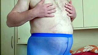 chubby german woman enjoys solo masturbation in blue leggings in her bedroom, playing with her feet and small cock