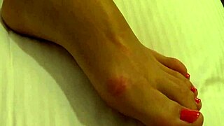 tanned petite 18+ girl with conical tits in close up.