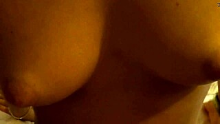 tanned petite 18+ girl with conical tits in close up.
