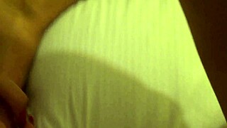 tanned petite 18+ girl with conical tits in close up.