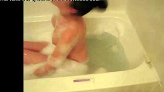 Look at this tiny red slut masturbating in the bathtub