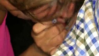 Mature blonde gives blowjob to young cock in public outdoor setting