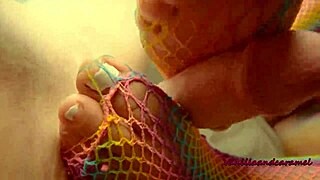 Sexy babe gives footjob while playing with her pussy!