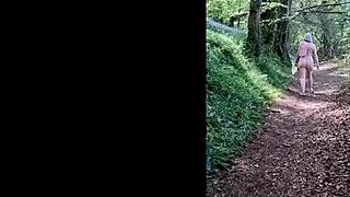 this naughty housewife is naked and wanking in the forest, reaching orgasm outdoors.