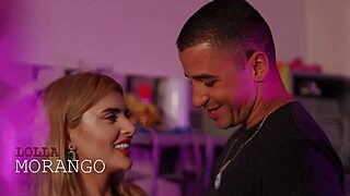 Behind the scenes, the Brazilian pornstar babe with big tits and a monster cock partner preps for anal action in a cute Latina setup.