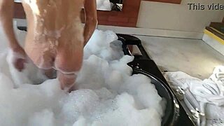 Watch the guy in feminine clothing fuck the busty Latina brunette's pear-shaped ass, burying his cock deep in her anus.