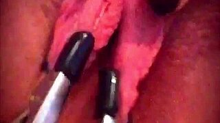 Big pink pussy lips dangled and stretched down with weights.