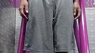 Black Brunette Uses Fitness Machine for Intense Gym Workout