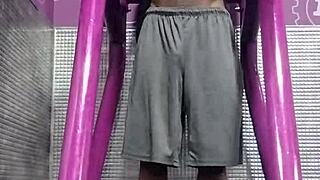 Black Brunette Uses Fitness Machine for Intense Gym Workout