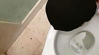 Slave endures public urinal humiliation