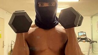 Black bodybuilder works out neck and shoulders outdoors in California for ladies.