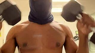 Black bodybuilder works out neck and shoulders outdoors in California for ladies.