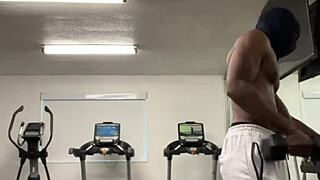 Black bodybuilder works out neck and shoulders outdoors in California for ladies.