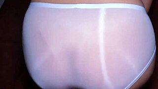 Wet hairy pussy peeks through see-through panties, filled with cum