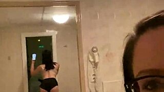 brunette milf in glasses snaps selfies from hotel bed and bathroom