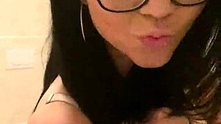 brunette milf in glasses snaps selfies from hotel bed and bathroom