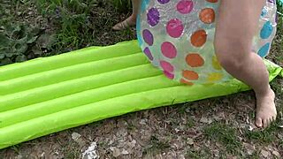 Hairy milf pisses on beach gear then fucks it outdoors