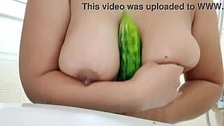 Cucumber slips deep between chubby oiled boobs!