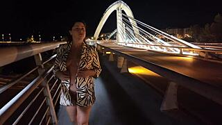 hey check this busty milf strutting braless on the bridge no panties flashing pussy