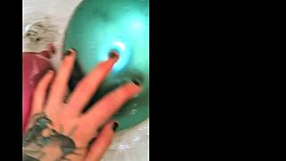 TATTOOED BABE POPS BALLOONS IN LATEX BATH FETISH FUN! 😈🛁