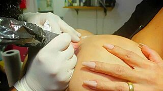 tattoo artist inks slut's tight asshole while pounding it deep with huge cock