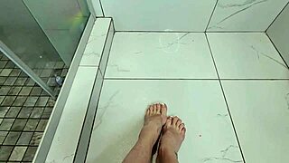 Milf gives early morning footjob on cock during steamy shower bath session