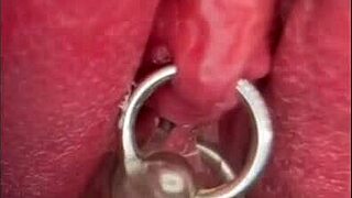close up shaved pussy pisses wet with pierced clit outdoors