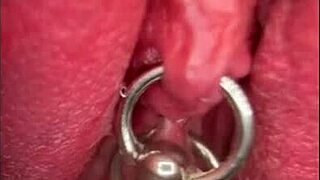 close up shaved pussy pisses wet with pierced clit outdoors