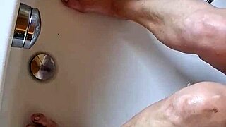 washing dirty mature german feet in bathtub