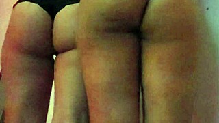 Two lesbians kiss passionately while shaking their asses seductively for the camera.