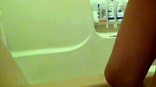 blonde pregnant beauty gets belly oiled in steamy shower massage